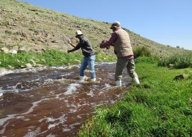 Researchers from the University of Jordan take measurements of stream runoff.